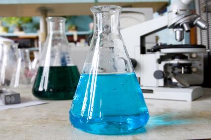 Two flasks of liquid on a lab table